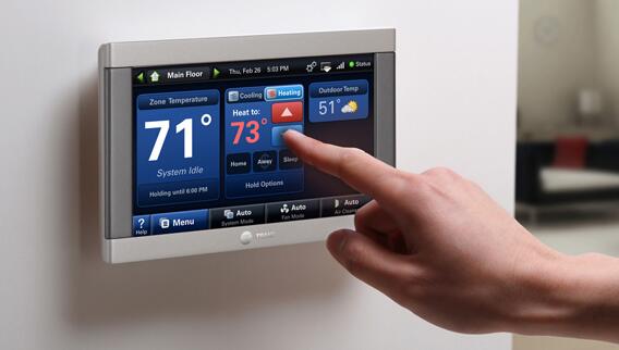 Trane Thermostat set up on the wall being set via its bright, colorful, touchscreen display.  